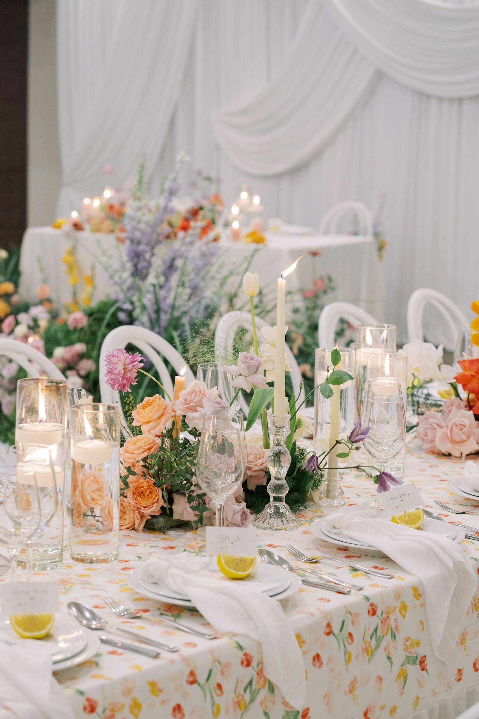 A wedding table with flowers, elegant glassware, and warm festive details